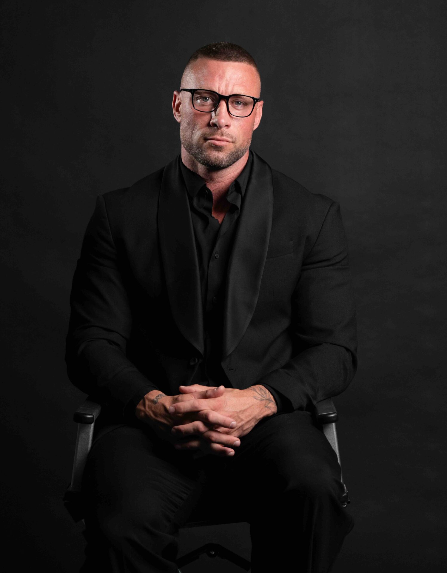 Mike Radoor seated in a black suit
